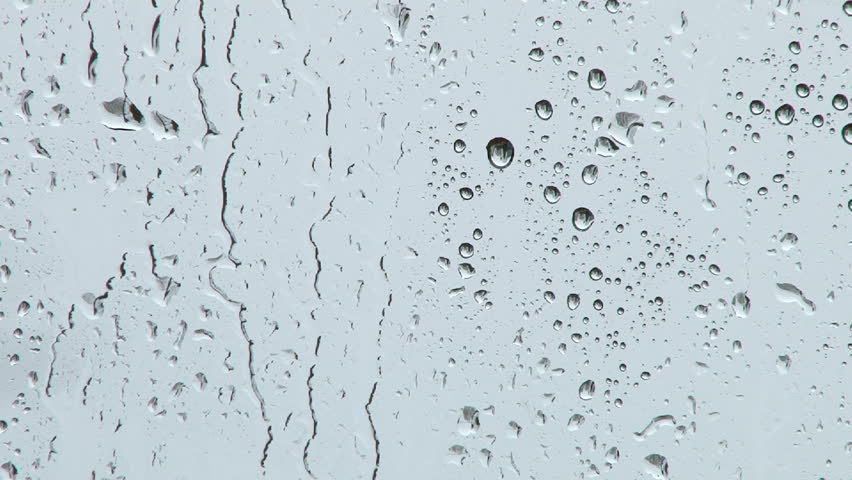 Rain falling on glass during rain storm background.