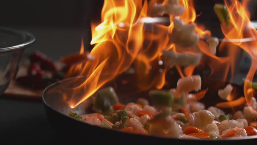 Stir fry into flaming pan in super slow motion, shot on Phantom Flex 4K | Shutterstock HD Video #23013244