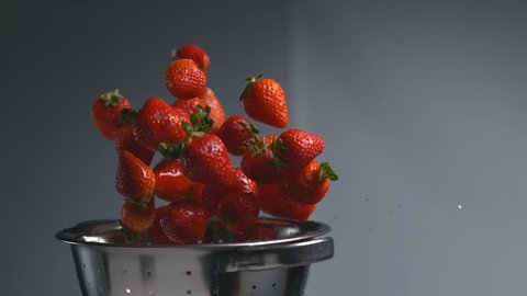 Strawberries flying out of colander in super slow motion, shot on Phantom Flex 4K