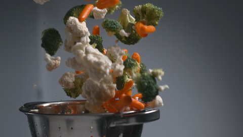 Vegetables flying out of colander in super slow motion, shot on Phantom Flex 4K