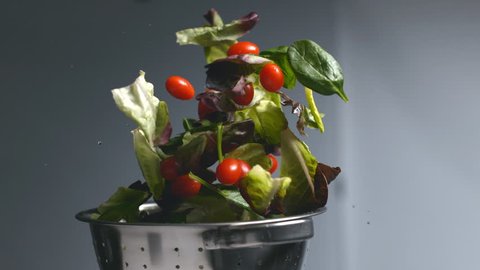 Salad flying out of colander in super slow motion, shot on Phantom Flex 4K