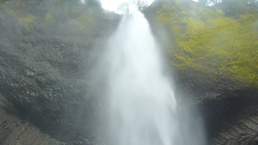 Low angle tilt down of Oregon waterfall scenic.