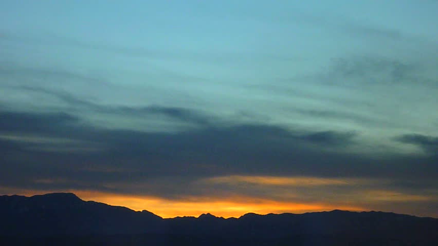 Sunset over mountains time lapse.