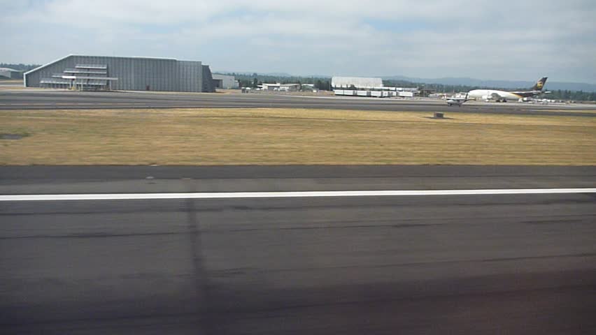 Riding in airplane at Portland, Oregon airport to take off.