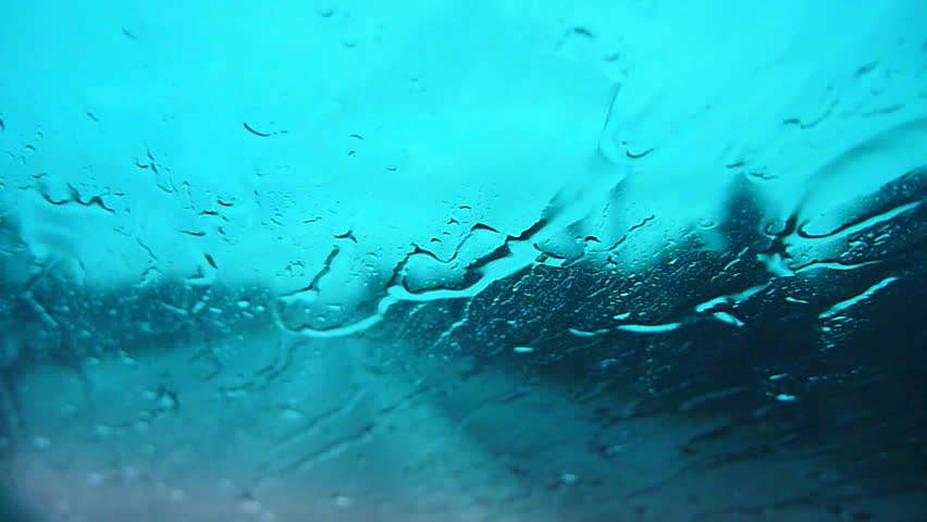 Interior car driving fast down highway during rain storm.