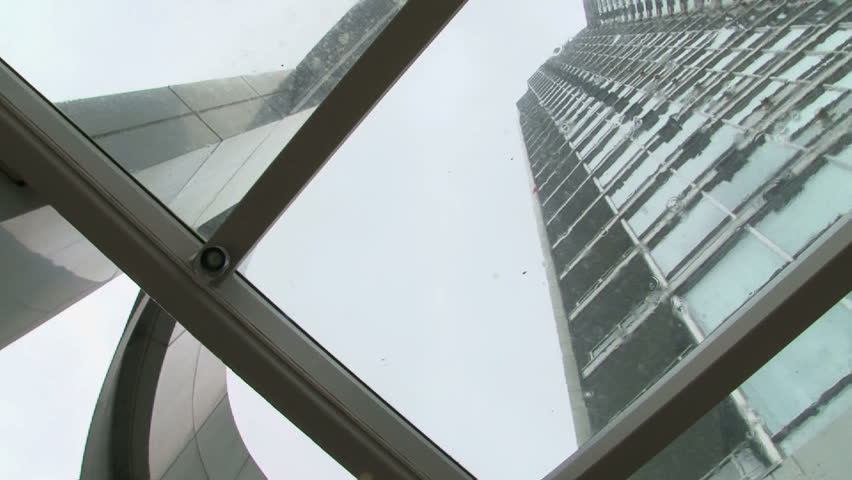 Circular tilt on tall buildings during rain storm.