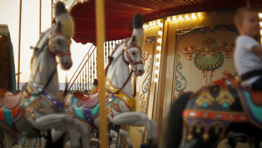 Horse rides on vintage merry-go-round carousel at fair