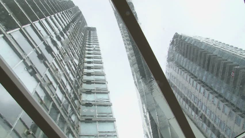 Circular tilt on tall buildings during rain storm.