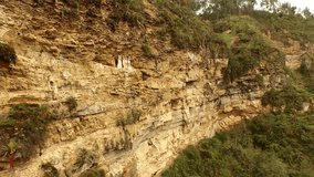 PERU: Aerial video footage of carajia. Sarcophagi of the Chachapoya culture in Peru, South America. Mummies located in the figures high in the cliffs