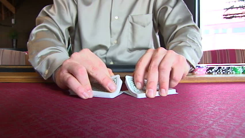 Slow Motion of professional poker dealer shuffling full deck of playing cards.