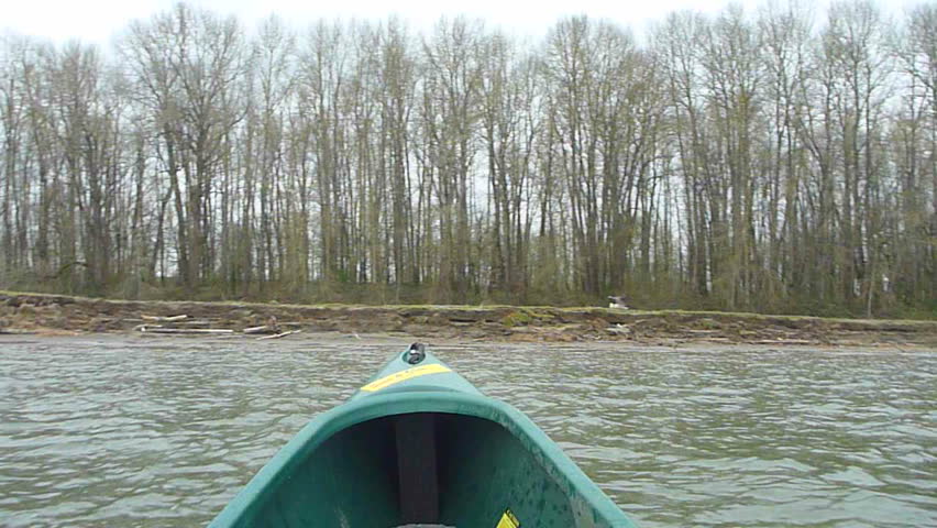 Point of view in canoe paddling across the Columbia River in Oregon, arriving to