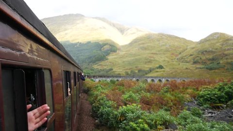 Glenfinnan Railway Viaduct in Scotland with the Jacobite steam train in Scotland, UK
