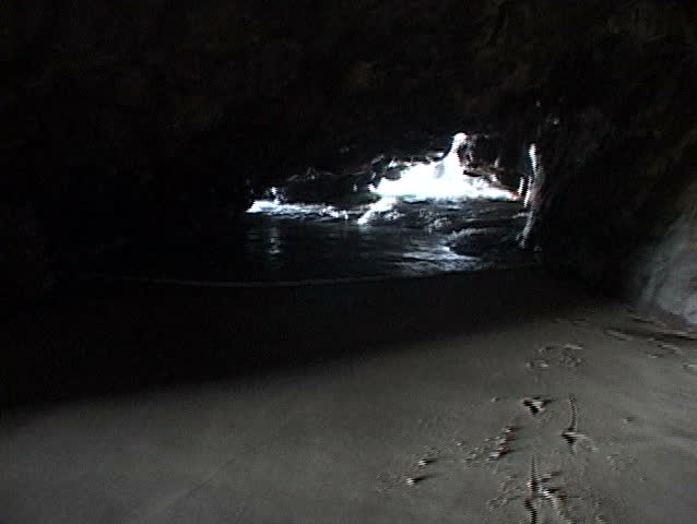 POV in cave (series edited), Kauai, Hawaii. Secret beach, tide comes in fast,
