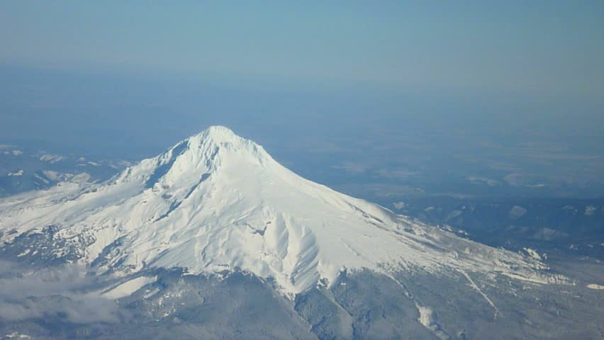 Flying in airplane over Oregon and Mt Hood with camera zoom out.