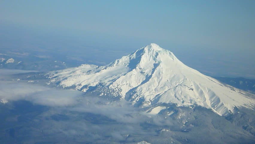 Flying in airplane over Oregon and Mt Hood.