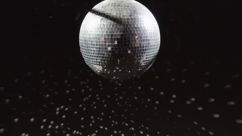 Disco mirrorball discoball spinning and reflecting light into a club venue