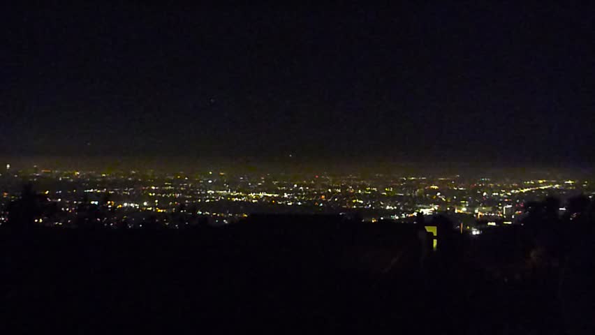 Zoom out at downtown Los Angeles from The Hills at night.