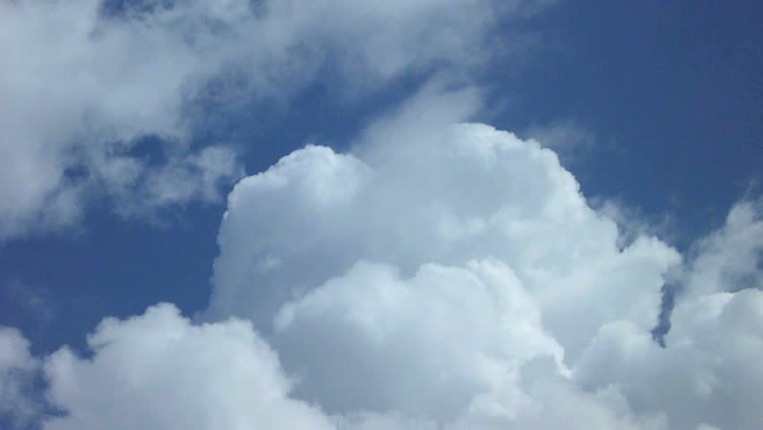 Large cumulus clouds build and swallow the blue sky time lapse.