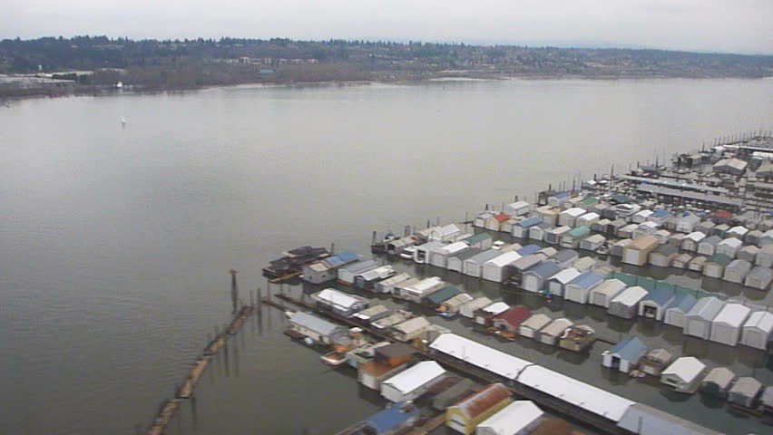 Flying in airplane over Columbia River and house boat marina close to airport.