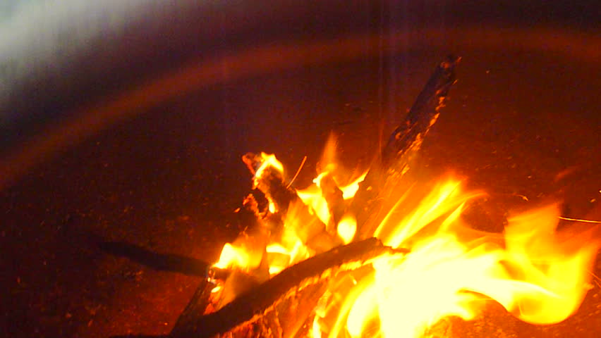 Fire burning in clay chiminea.