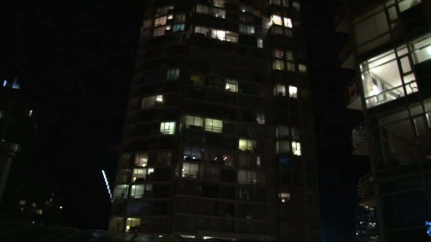City life at night in Vancouver Canada showing many people in their condominium