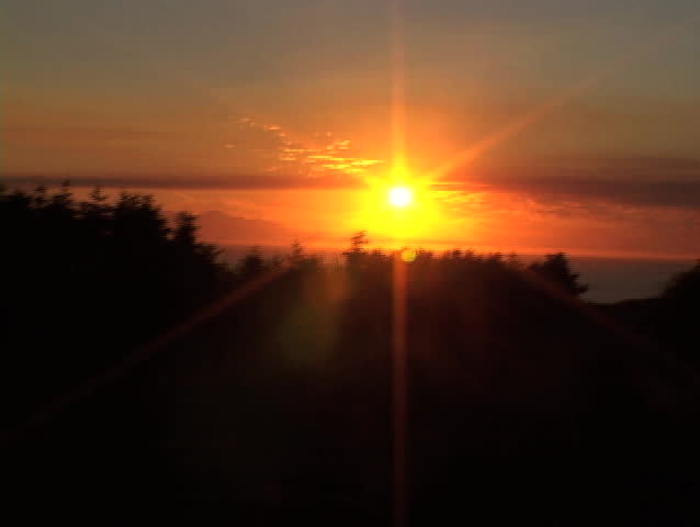Sun sets in Victoria Canada while driving parallel.