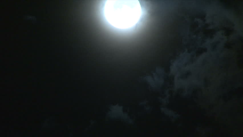 Bright full moon on partly cloudy night time lapse. 1920 x1020 Full HD.