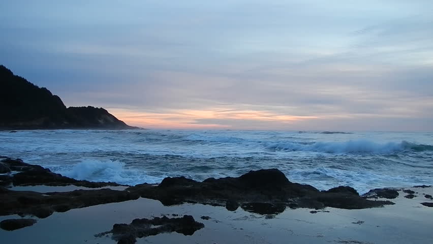 Rough seas bring waves crashing on the Oregon Coast at sunset.