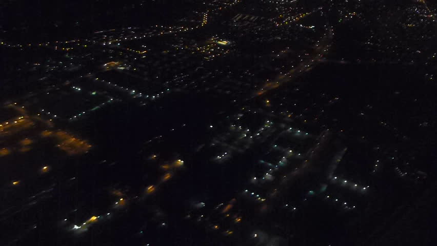 Flying in airplane over Portland, Oregon at night.
