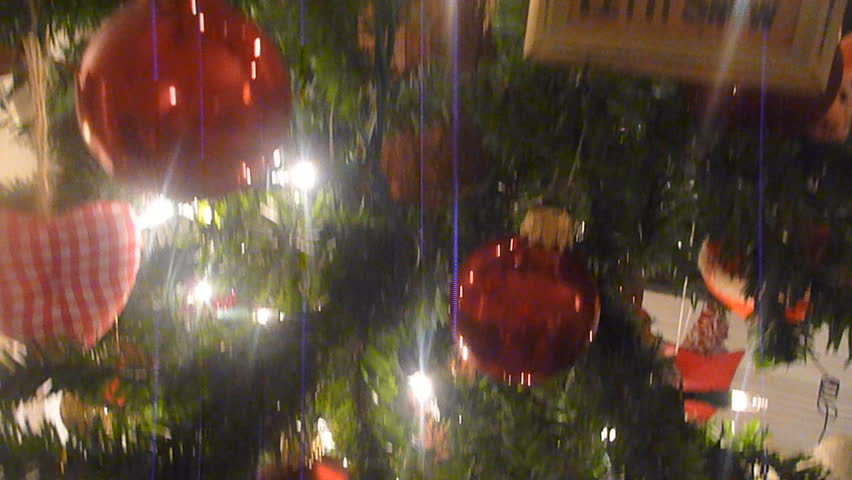 Tilting down camera on Christmas tree decorations.