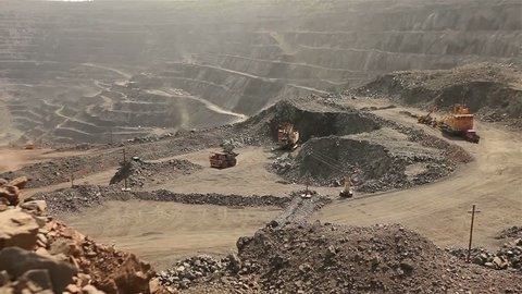 Open pit iron ore mining, a big yellow mining truck at work, working in a quarry, big yellow heavy truck in open cast mine, mining of iron ore, the overall plan, Dump Truck, sunny day 