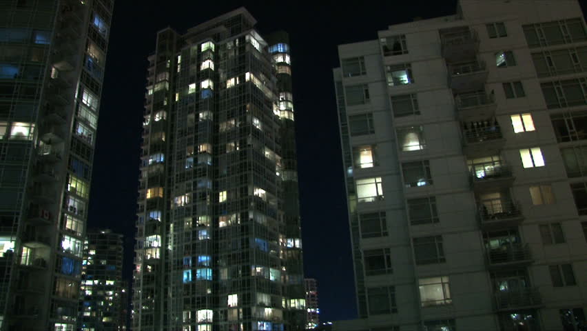 City life at night in Vancouver Canada showing many people in their condominium