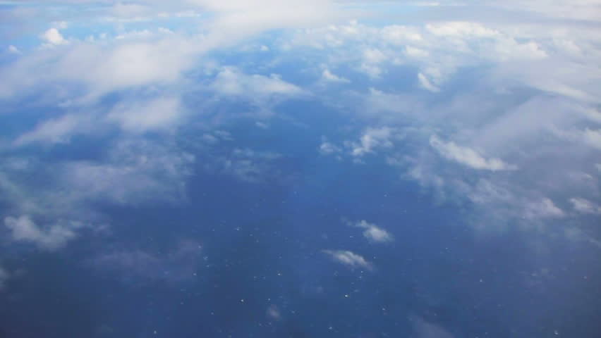 Flying in airplane over Pacific ocean dropping in altitude flying through clouds and little turbulence. Royalty-Free Stock Footage #2304410