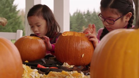 Kids carving pumpkins for Halloween