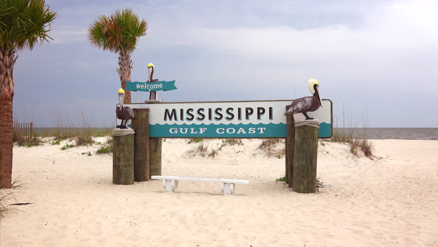 Welcome to Mississippi Gulf Coast sign on sandy beach in Gulfport