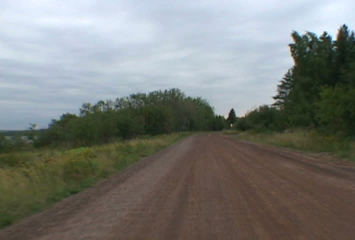 Driving fast on dirt, country roads in Minnesota.