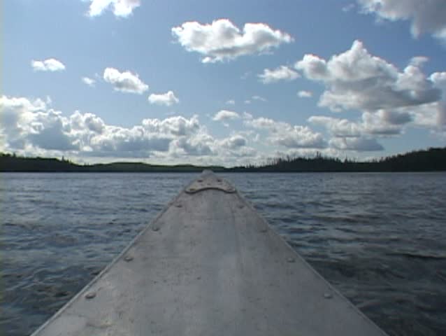 Point of view while riding inside aluminum canoe at lake in the Minnesota