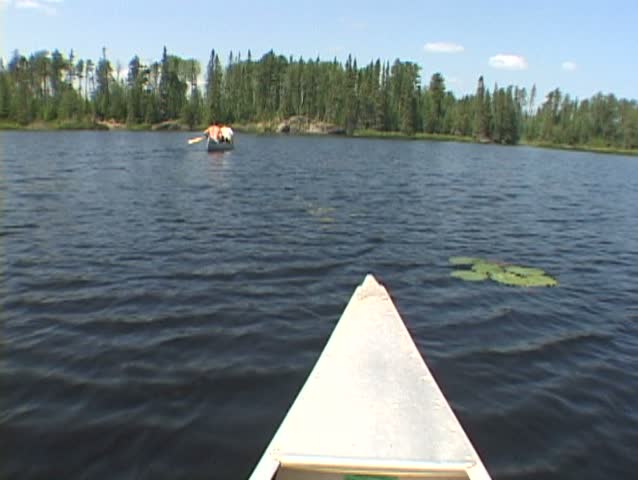 Point of view while riding inside aluminum canoe at lake in the Minnesota