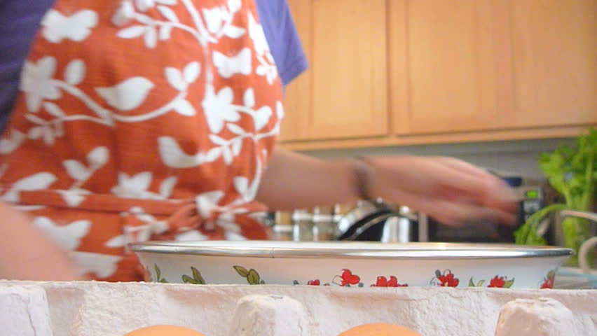 Woman preparing scrambled egg breakfast.