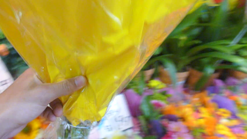 Series with person picking out and bouquet of flowers at store.