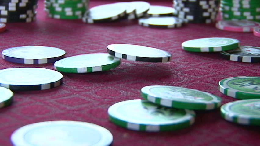 Slow Motion of poker chips falling on card table in casino close up.