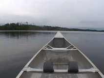 Point of view while riding inside aluminum canoe at lake in the Minnesota Boundary Waters. More clips available in series.