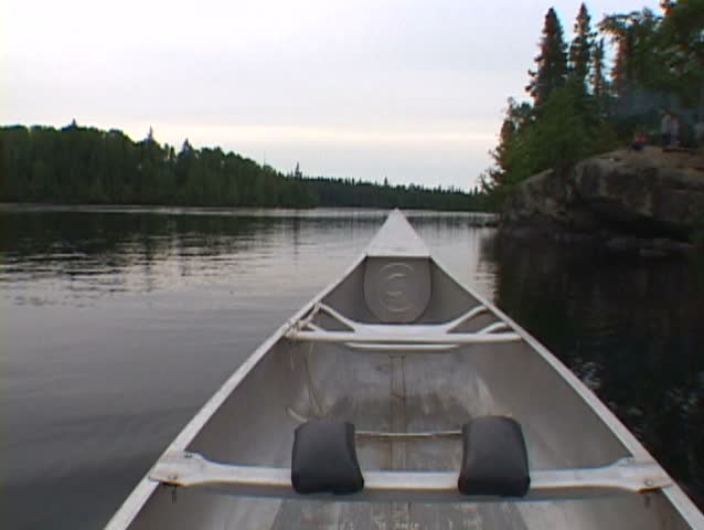 Point of view time lapse while riding inside aluminum canoe at lake in the