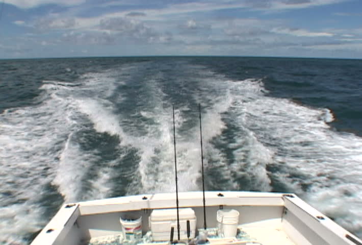 Florida charter fishing boat / yacht in Atlantic Ocean showing stern and bow.