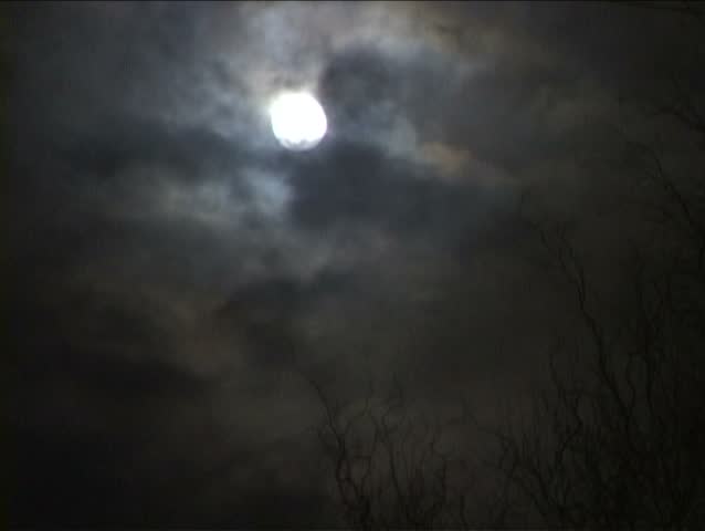 Full Moon with great storm layering clouds over night skyline.