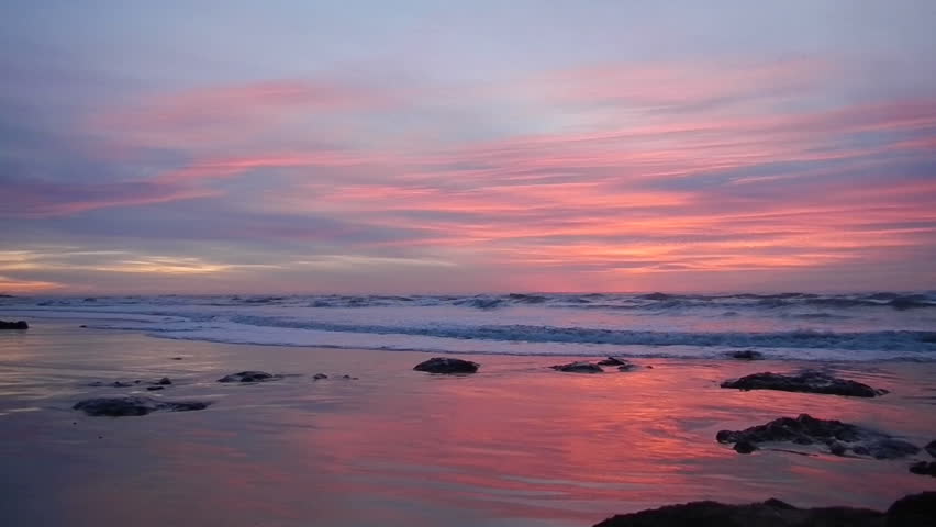 Vivid colors in clouds with waves during sunset over the beautiful Pacific