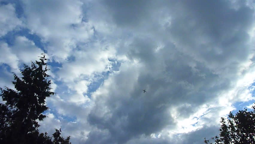 Airplane flying overhead on cloudy day in Portland, Oregon.