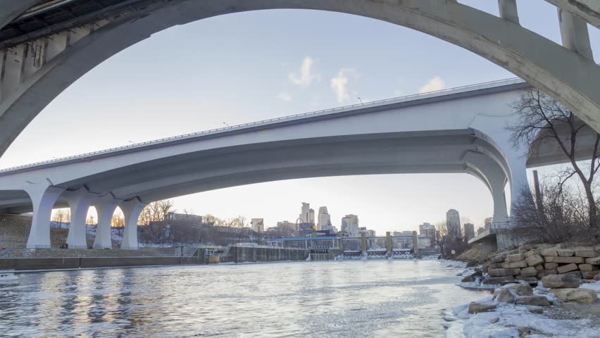 Sunset Behind the 35W and 10th St Bridges and Distant Minneapolis Skyline in the Winter 4K UHD Timelapse