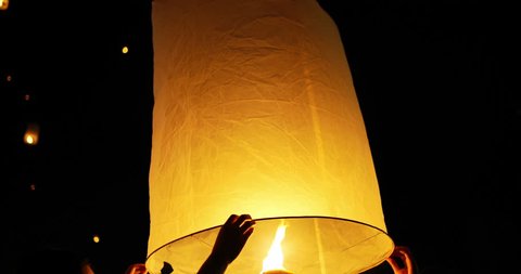 Hands holding sky lantern at buddhist festival in Thailand Arkivvideo