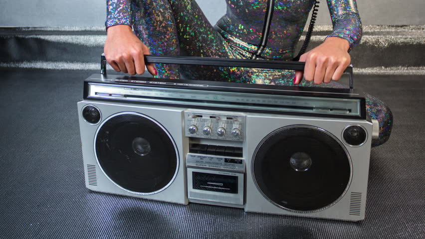 sexy cool woman posing with different changing vintage radios and ghettoblasters